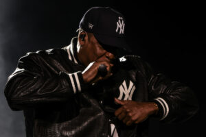 # JAŸ-Z Opens Three-Night Yankee Stadium Run With Surprise Guests and Career-Spanning Set NEW YORK (AP) — JAŸ-Z launched the first of three sold-out performances at Yankee Stadium on Friday night, delivering a career-spanning set that featured surprise appearances from Beyoncé, Blue Ivy Carter, Nas, Alicia Keys, Memphis Bleek, and Jaz-O. The concert marked the opening night of the series, dubbed "JAŸ-Z 30," celebrating the rapper's legacy with a performance that blended early classics, chart-topping hits, and collaborations with longtime friends and family. Beyoncé joined JAŸ-Z to open the show with "Can't Knock the Hustle," the pair's rendition of the 1996 track setting the tone for an evening that revisited much of the Brooklyn native's catalog. JAŸ-Z continued with songs including "Politics as Usual," "Made in America," "Brooklyn's Finest," and "I Love the Dough." Later in the performance, Nas took the stage for a trio of New York hip-hop staples: "Dead Presidents," "The World Is Yours," and "N.Y. State of Mind," before remaining onstage for "Where I'm From." The appearance underscored the longtime relationship between the two rap icons, whose rivalry evolved into one of the genre's most notable reconciliations. Blue Ivy Carter also made an appearance, playing piano to introduce "Feelin It." Alicia Keys later surprised the audience with a performance of "Empire State of Mind," the Grammy-winning anthem that has become synonymous with New York City. Memphis Bleek joined JAŸ-Z for "Coming of Age," while Jaz-O also appeared during the evening. The audience included a wide range of entertainers, athletes, and business leaders. Among those in attendance were LeBron James, Leonardo DiCaprio, Kevin Hart, Adrien Brody, Tobey Maguire, Megan Thee Stallion, Jack Dorsey, DJ Khaled, Swizz Beatz, Jadakiss, La La Anthony, Kelly Rowland, Vanessa Bryant, OG Anunoby, Robinson Canó, Rudy Gay, P.J. Tucker, Fabolous, Sheek Louch, Lukas Haas, and Yan Diomandé. JAŸ-Z also showcased multiple wardrobe changes throughout the night. He opened wearing a Planes baseball cap, a custom CROC baseball jacket designed by June Ambrose, Fear of God trousers, a Planes T-shirt, and his Nike Air Force 1 collaboration sneakers. He later changed into a Givenchy suit layered with a Maison Bootleg piece and Timberland boots before closing the concert in a workwear-inspired ensemble featuring a custom umpire-style proof vest, a striped Japanese denim barn jacket, carpenter pants designed by Ambrose, and Timberland boots. The nearly three-dozen-song set highlighted every stage of JAŸ-Z's career, moving from early recordings such as "Can I Live," "D'evils," "Friend or Foe," and "Regrets" to later releases including "No Church in the Wild" and "Made in America." The celebration continues Saturday with "JAŸ-Z 25" before concluding Sunday with "JAŸ-Z Extra Innings."