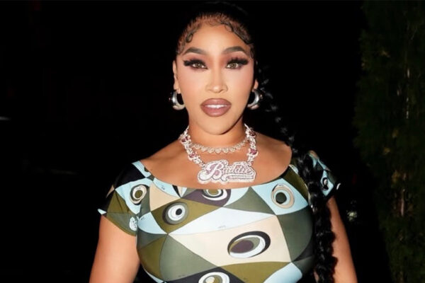 Rapper & Reality TV Star Natalie Nunn Rocks Emilio Pucci Occhi-Print Off-The-Shoulder Fitted Jumpsuit In NYC, Paired With Silver Chanel Mini Hobo Purse ($9,000), Giuseppe Zanotti New Cruel 105 Silver Heels, & New Baddie Records Platinum $150,000 Necklace
