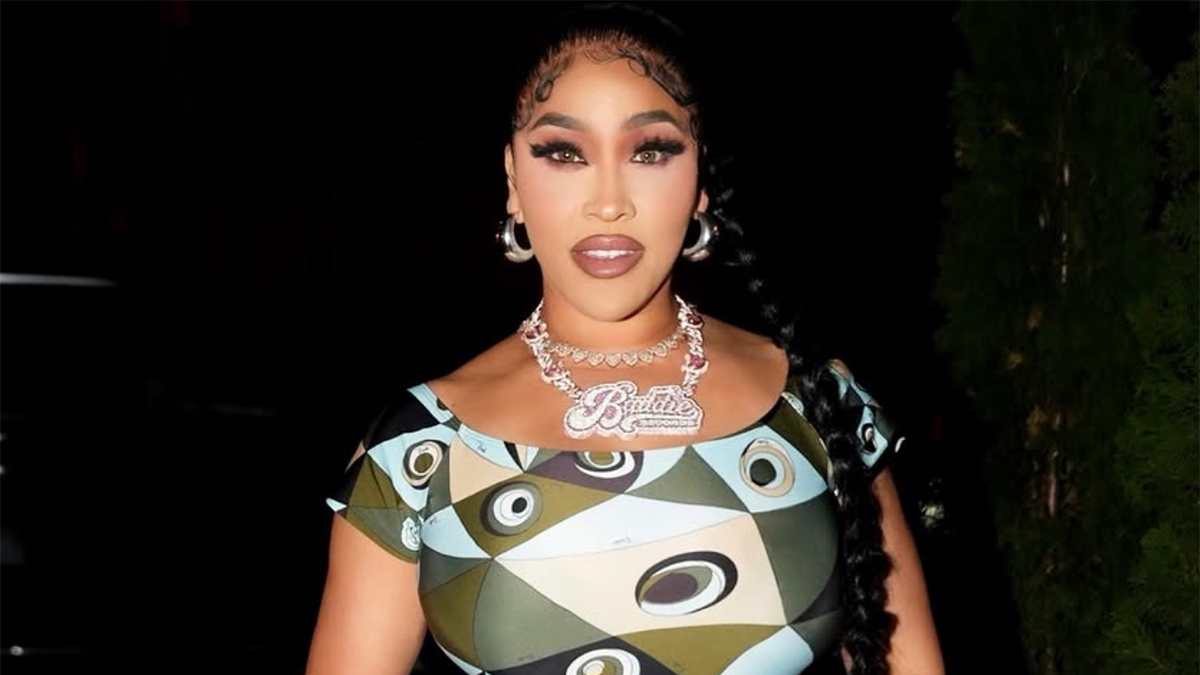 Rapper & Reality TV Star Natalie Nunn Rocks Emilio Pucci Occhi-Print Off-The-Shoulder Fitted Jumpsuit In NYC, Paired With Silver Chanel Mini Hobo Purse ($9,000), Giuseppe Zanotti New Cruel 105 Silver Heels, & New Baddie Records Platinum $150,000 Necklace